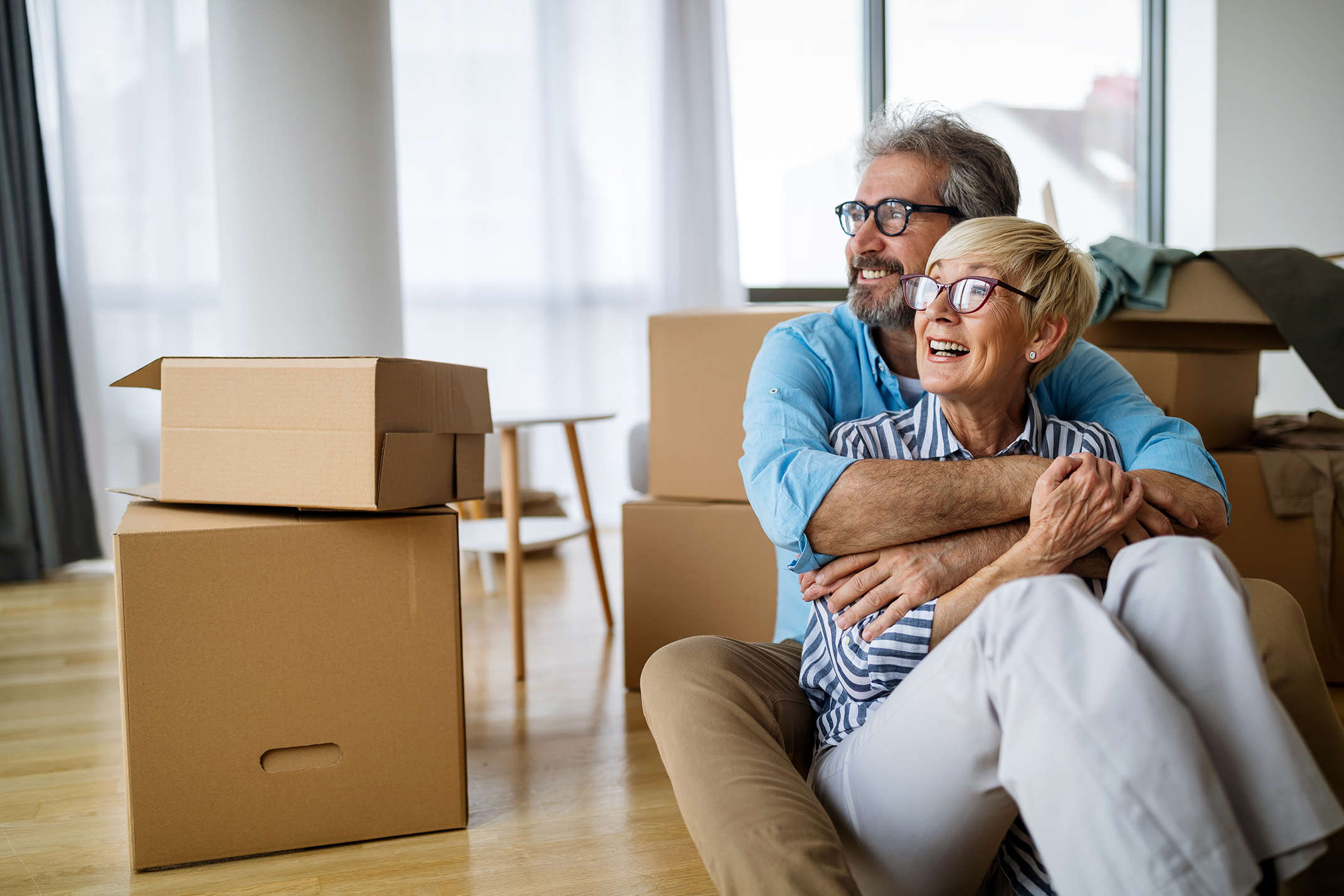 HC - Happy senior couple moving in new home_AdobeStock_410082584
